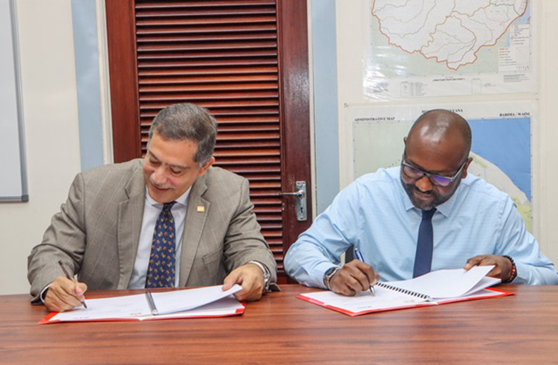 From left: IICA’s Representative in Guyana, Wilmott Garnett and Ministry of Health’s Permanent Secretary, Malcolm Watkins signing the agreement on Wednesday