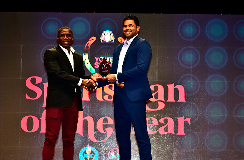 Sportsman of the year boxer Desmond Amsterdam receives his plaque from Minister of Culture, Youth and Sport Charles Ramson Jnr. (Adrian Narine photo)