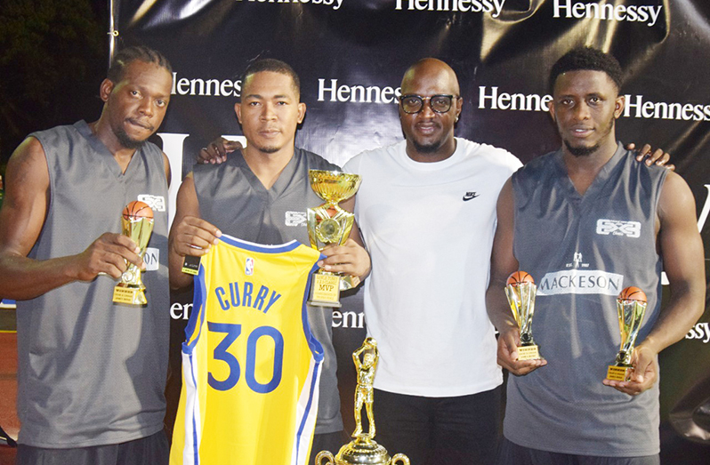 Flash Back! From left, members of Team Linden, Harold Adams, Shelroy Thomas, Organiser Rawle Toney and Stanton Rose pose with their replica trophies and Championship rings.