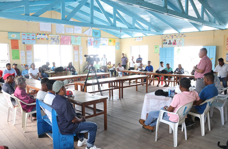 Minister of Housing and Water, Collin Croal, engages residents of Wakapoa (DPI photo)