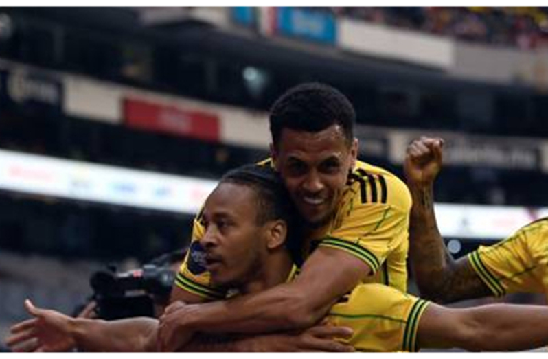 Bobby Reid (front) is joined by teammate Ravel Morrison after scoring Jamaica’s opener on Sunday.