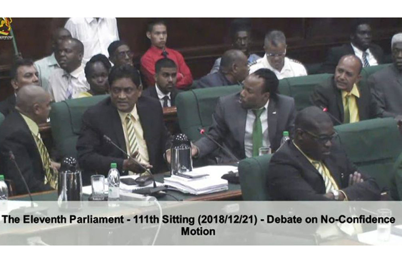 Charrandass Persaud being abused by his colleagues on his left and right, minutes after he voted in favour of an Opposition-sponsored No-Confidence Motion.