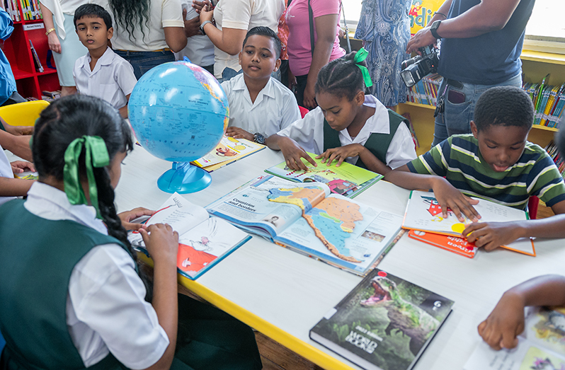 Children of the Mon Repos Primary School on the East Coast of Demerara enjoy their new library (Delano Williams photo)