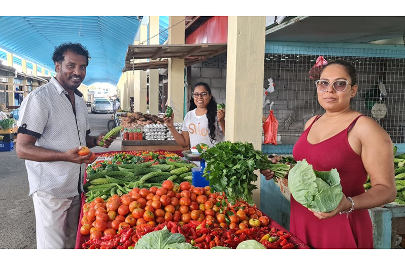 R3PSInc Head Halim Khan with vendors and their fresh supplies at the Parika Market on Saturday