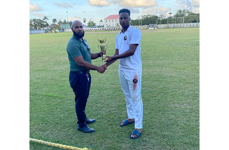 All-rounder Ronaldo Alimohamed receives his MVP award from GCB executive Anthony D'Andrade following the match.