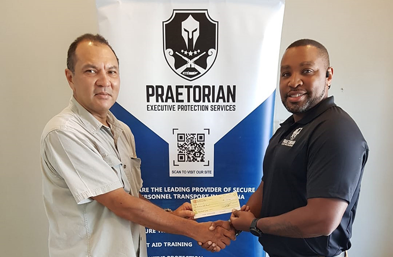Handing over of sponsorship funds from Praetorian’s CEO, Mr. Dallas Thomas in presence of GSSF’s Director and Treasurer, Mr. Andrew Phang.