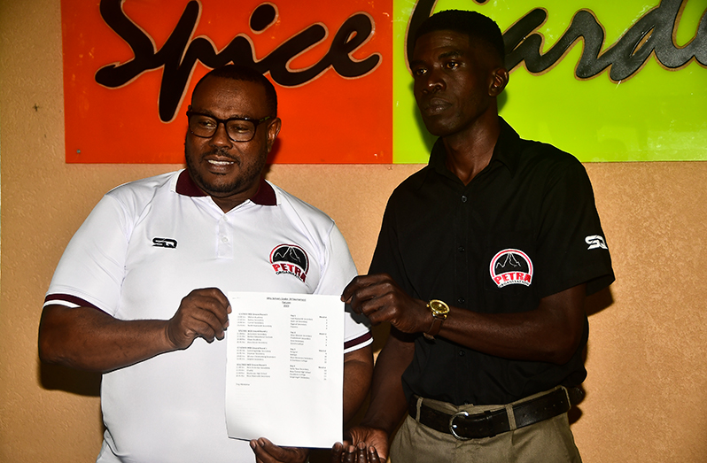 Petra Organisnation Co-Director Troy Mendonca (left) displaying the event fixtures alongside entity member, Mark Alleyne