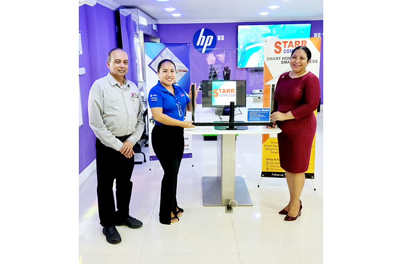 (From right) Vice-Chancellor (VC) of the University of Guyana (UG) Prof. Paloma Mohamed Martin receives one of 100 Virus | Flu Protection Shields from Marketing Manager Penny Francis in the presence of President of STARR Computer, Mike Mohan