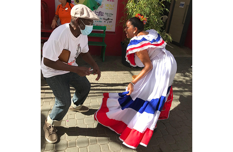 Boston-based veteran Guyanese Journalist, Hubert Williams, enjoys a moment of light-hearted interaction with a youngster while on his recent visit to his homeland, Guyana