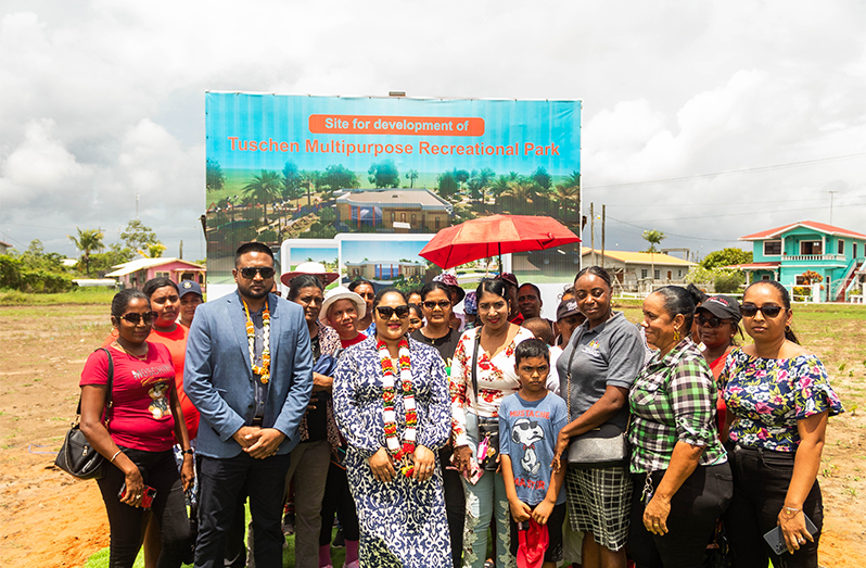 First Lady Arya Ali, Minister Nigel Dharamlall and residents near the billboard which was erected at Tuschen (Shaniece Bamfield photos)