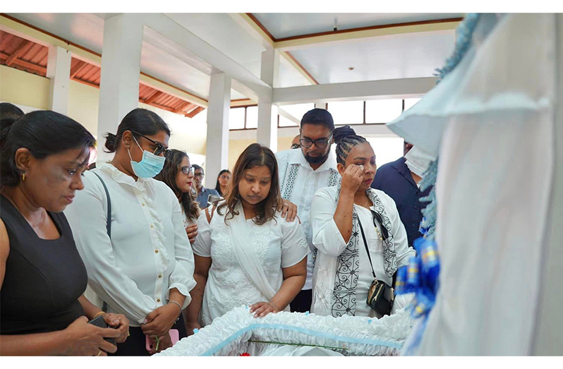 President Dr. Irfaan Ali comforts a relative of Police Corporal Avandel Kevin Narine, during the funeral service at the Memorial Garden's Funeral Home, Princes Street, Georgetown.