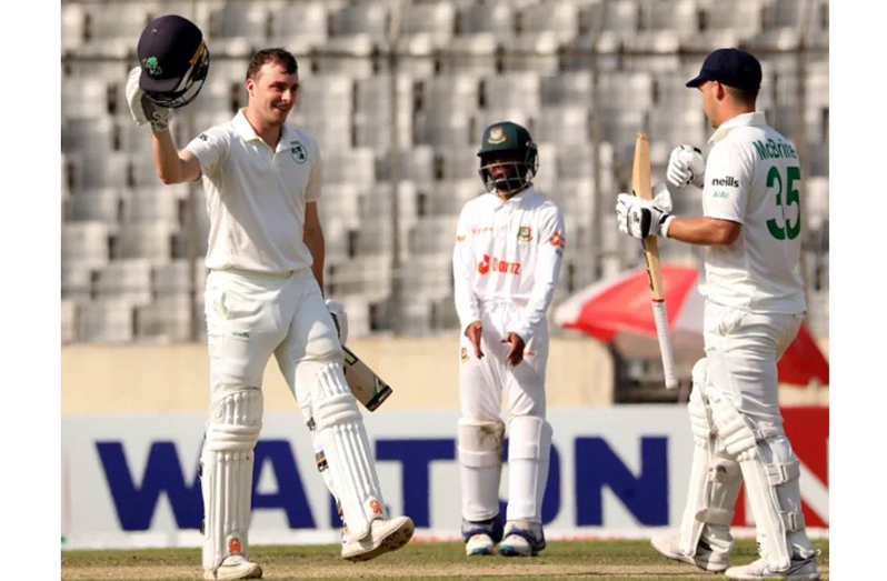 Lorcan Tucker celebrates his ton with Andy McBrine  •  (BCB)