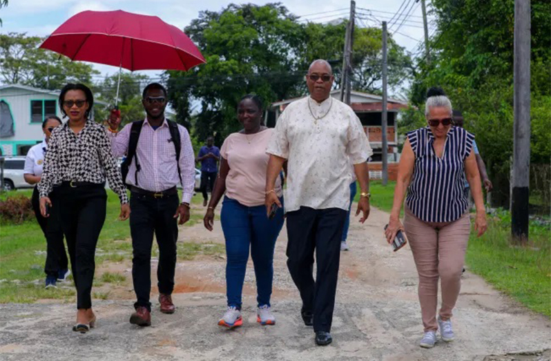 Minister of Public Works, Bishop Juan Edghill and Minister of Tourism Industry and Commerce, Oneidge Walrond along with community representatives during a walkabout (DPI photo)