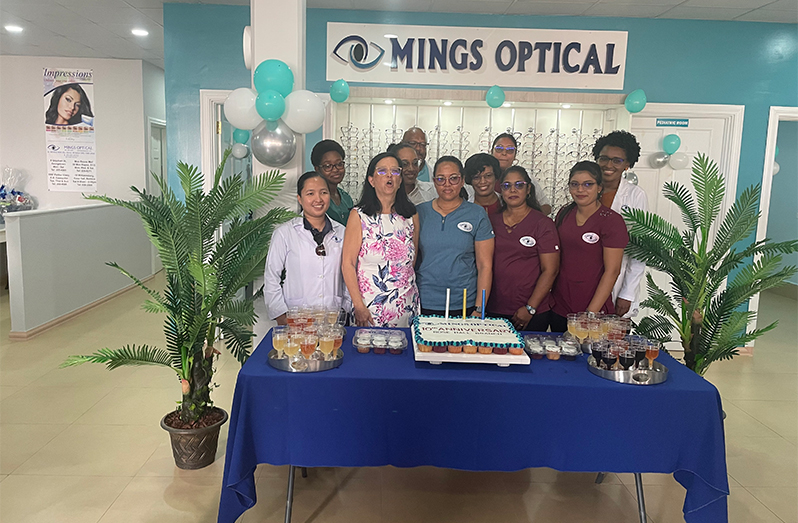 Dr. Michelle Ming (second left, front row) stands with staff of Mings Optical during the 10th Anniversary celebration of their Berbice Branch on Saturday