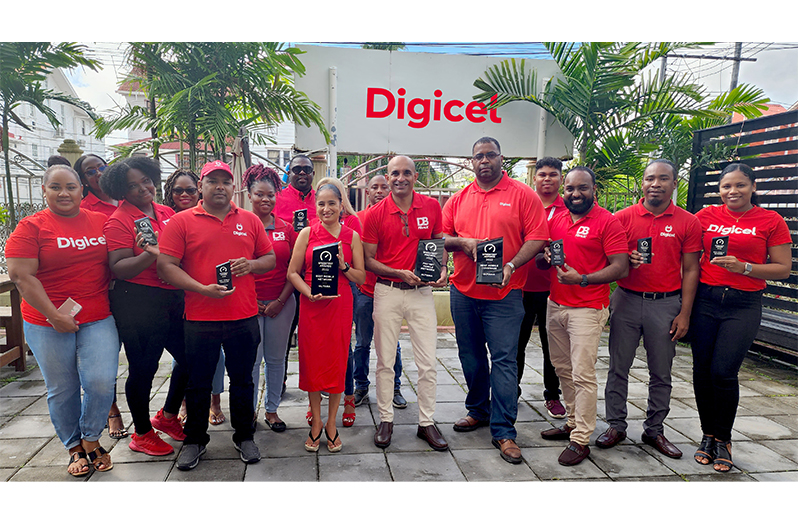 Members of Digicel’s senior management team and staff take time out for a photo op with the Ookla Speed test awards they recently received