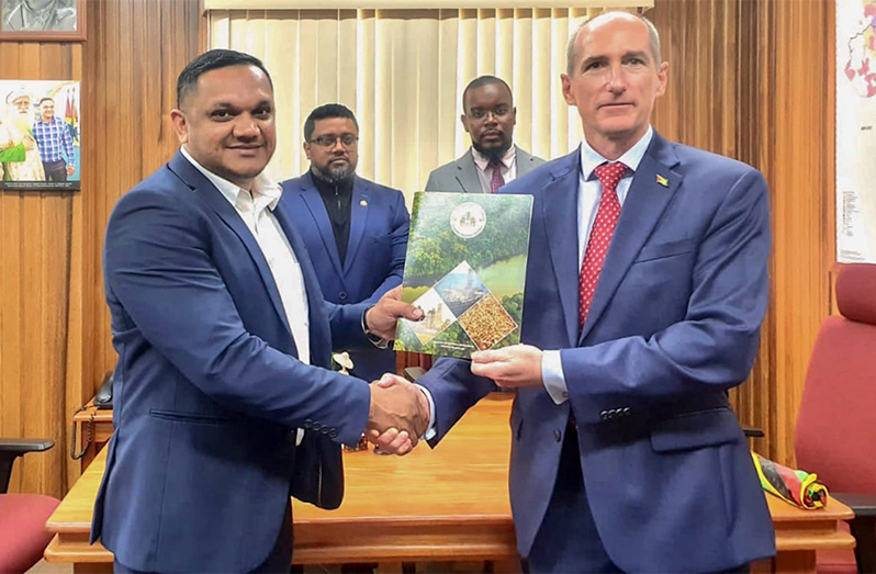 Minister of Natural Resources, Vickram Bharrat, presents ExxonMobil Guyana President, Alistair Routledge, with a Letter of Approval for the company’s 2023 Annual Local Content Plan.