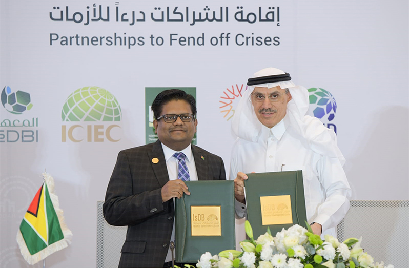 Dr. Ashni Singh and IsDB President Dr. Muhammad Al Jasser shortly after signing the watershed MoU in Saudi Arabia on Friday (Ministry of Finance photo)