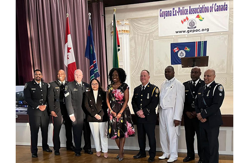 GEPAC President Floyd Blyden (third from right), MPP Mitzie Hunter (fifth from right) and Consul General (ag) Grace Joseph with Officers from Toronto and York Police Services.