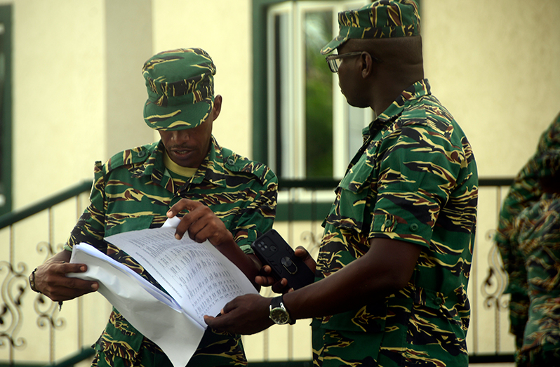 GDF ranks check the voters’ list for their names (Adrian Narine photo)