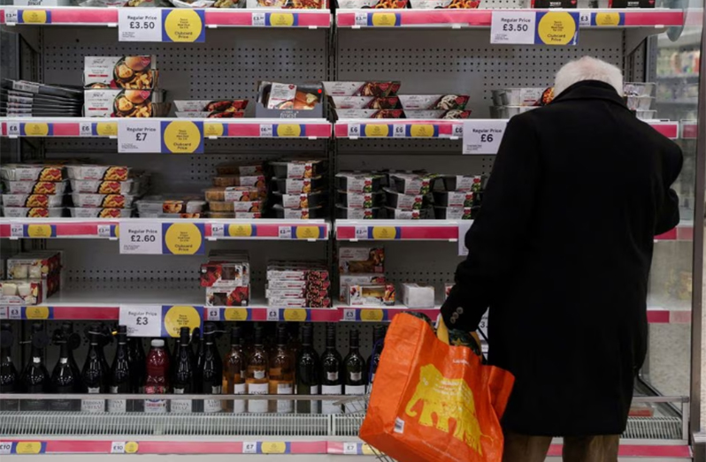 A man shops next to Clubcard price branding inside a branch of a Tesco Extra Supermarket in London, Britain, February 10, 2022. (REUTERS/Paul Childs/File Photo)