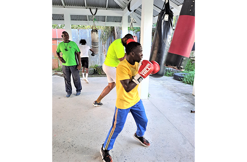 Coach Poole(left) supervises  a  sparring session