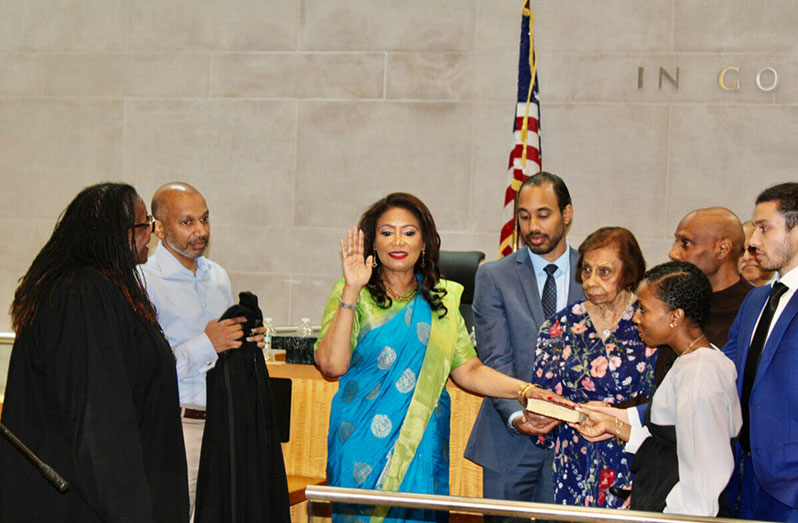 Judge Andrea Ogle, (hand raised centre) being inducted as Judge of the Civil Court of the City of New York by Honourable Judge Edwina Richardson-Mendelson, far left, surrounded by Ivy Ogle, Nigel Ogle, Dr. Kevin Ogle, Adreena Ogle-Crawford, Alexander Ogle, Dr. William Ogle, in the Queens County Civil Court, on Sutphin Boulevard, on Friday 16, 2023