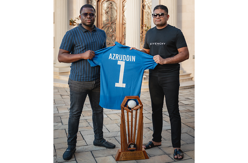 Caption: Azruddin Mohamed collects his tournament jersey from Co-Director of the tournament, Akeem Greene