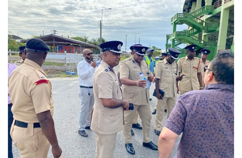 Deputy Commissioner 'Operations' Mr Ravindradat Budhram (second from left) looks on as Regional Division Commander 4 (A), Assistant Commissioner Simon Mc Bean makes a point