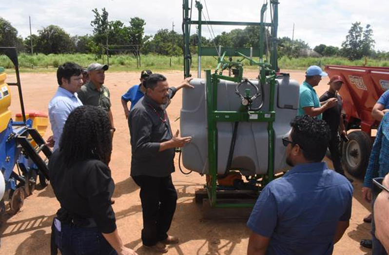 Knowledge being shared with Guyanese farmers about the operation of farming equipment and machinery in Brazil