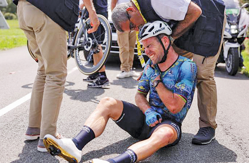 Mark Cavendish was helped into an ambulance having suffered a suspected broken collarbone