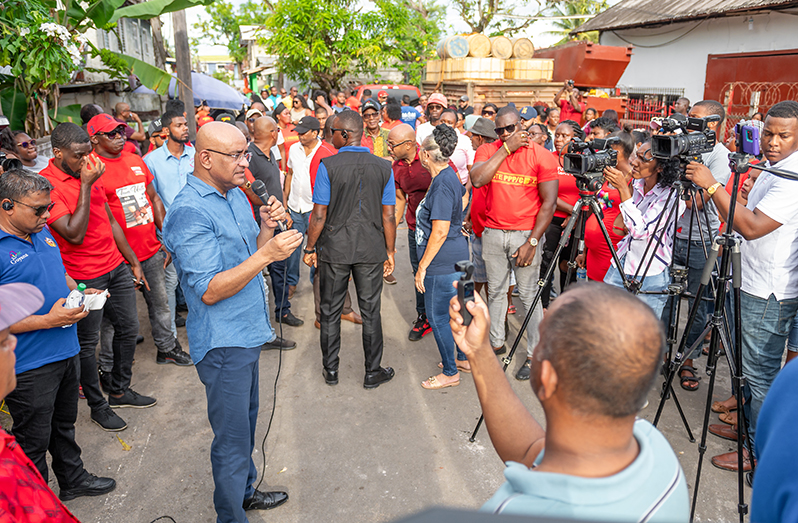 Vice-President, Dr. Bharrat Jagdeo (left) speaking with a crowd gathered at Yarrow Dam (Delano Williams photo)