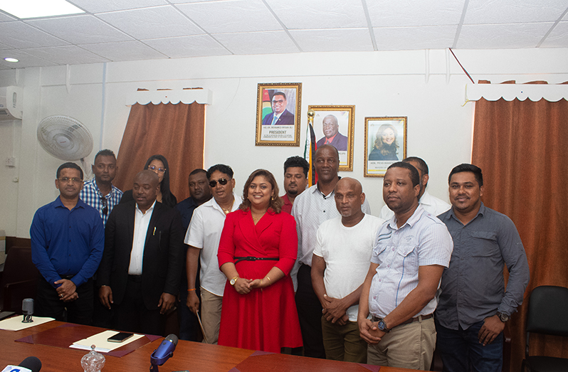 Minister of Education Priya Manickchand (centre), flanked by contractors and other MoE officials (Shaniece Bamfield photo)