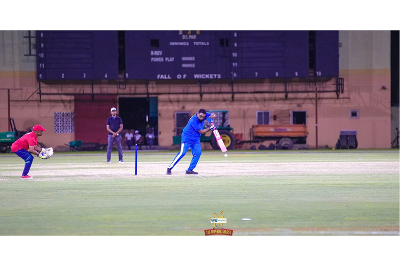 President Dr. Irfaan Ali drives through the covers during the ‘Cricket for Charity’ match on Saturday at the National Stadium, Providence