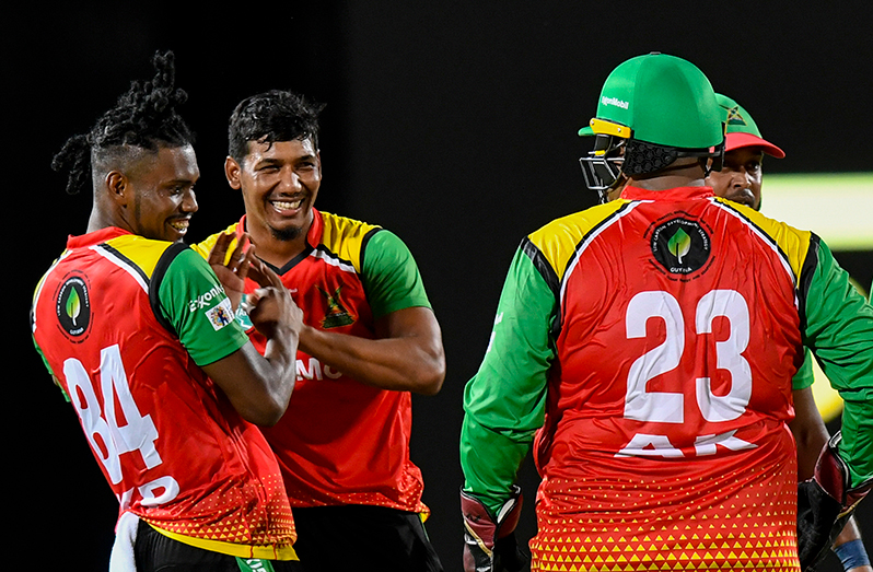 Gudakesh Motie (2L) and Keemo Paul (L) of the Guyana Amazon Warriors celebrate the dismissal of Evin Lewis of Saint Kitts and Nevis Patriots during the Men's 2023 Republic Bank Caribbean Premier League (match 8) between Saint Kitts and Nevis Patriots and Guyana Amazon Warriors at the Warner Park Sporting Complex on August 24, 2023 in Basseterre, Saint Kitts and Nevis (Photo by Randy Brooks/CPL T20 via Getty Images