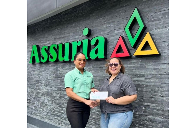 Jordana Ramsay-Gonsalves (right), Event Organiser, and Ashley Layne, Representative of Assuria Insurance seal the partnership with a handshake