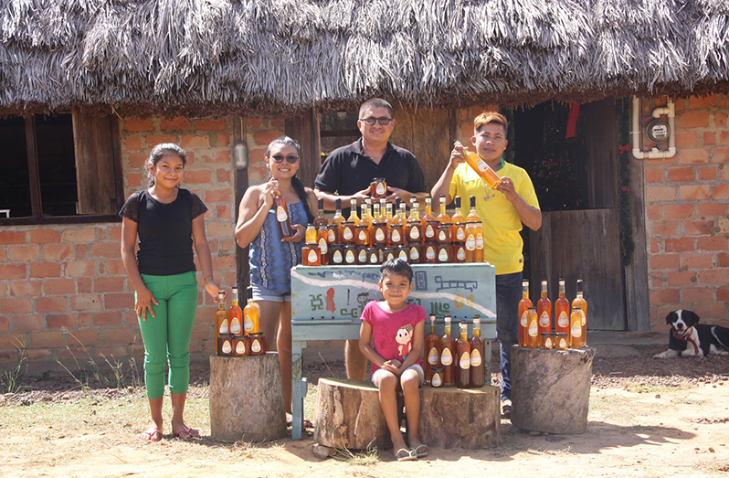 Yimochi and his family displaying their honey in Lethem