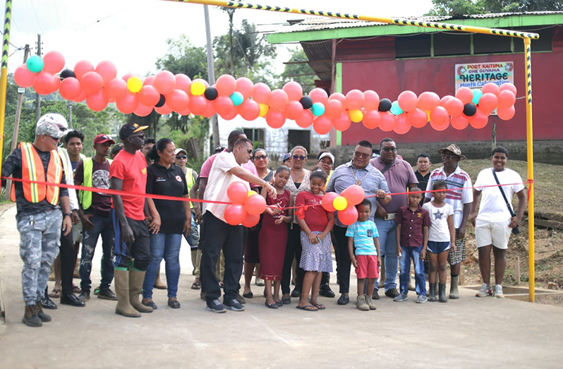 Minister of Housing and Water, Collin Croal cuts the ribbon to officially open the road (Ministry of Housing photos)