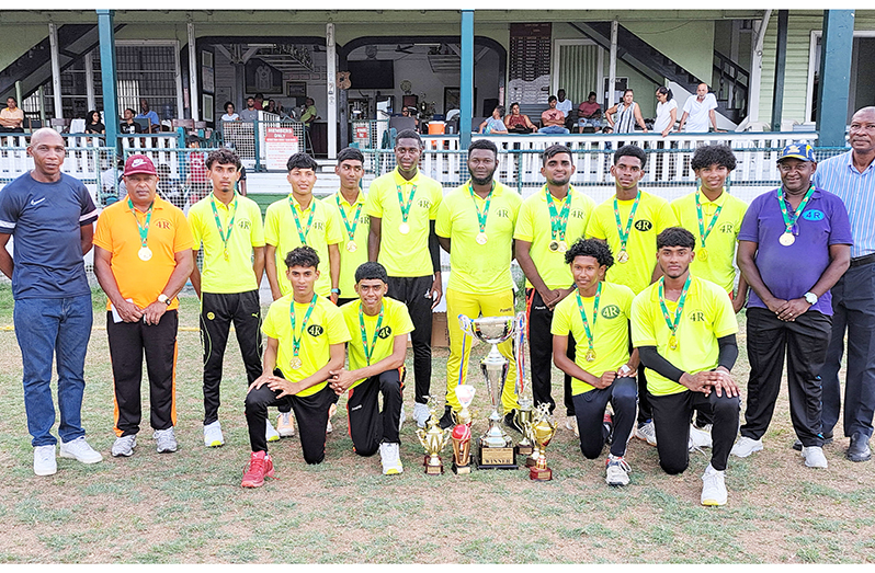 Champions 4R Lions team with GCA officials, Roger Harper (right) and Shawn Massiah (left) displaying their trophies (Sean Devers photo)