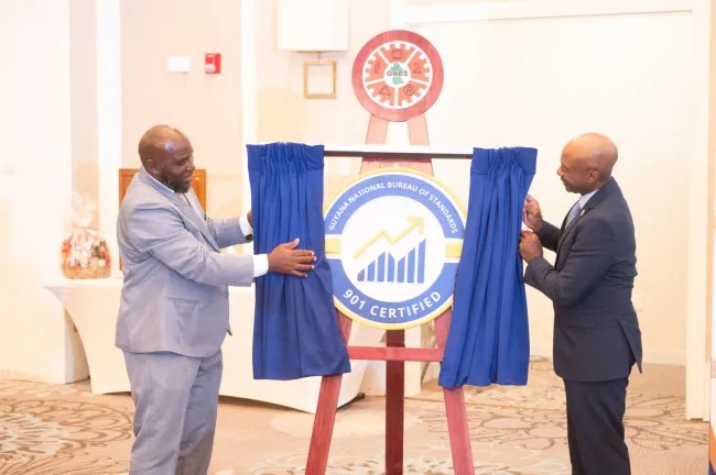 Executive Director of the Guyana National Bureau of Standards (GNBS), Al Fraser and Project Coordinator of CARICOM Regional Organisation Standards and Quality (CROSQ), Terry Hutchinson, unveiling of the standards mark (DPI photos)