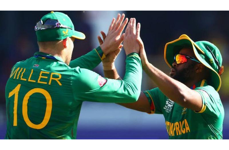 David Miller celebrates after taking a catch with team-mate Temba Bavuma.