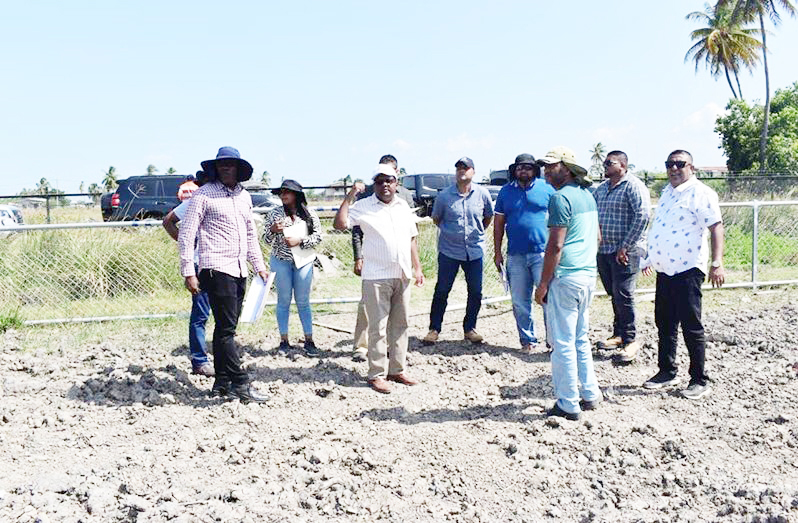 Finance Minister Dr Ashni Singh inspecting a community ground in Berbice