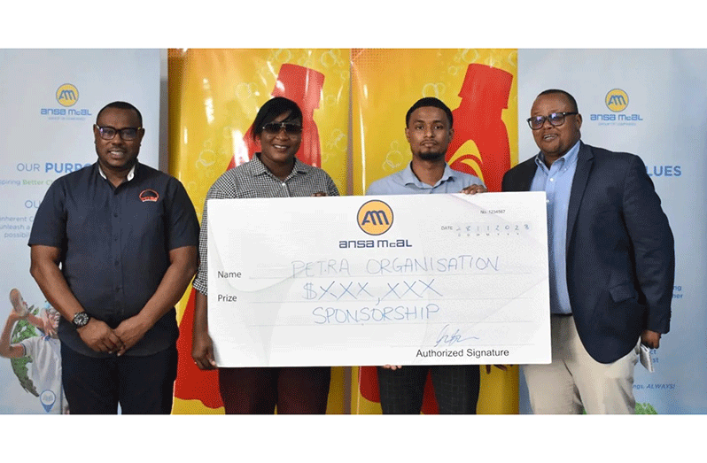 Petra Organisation member Jacqueline Boodie receives the sponsorship cheque from Non-Alcoholic Brand Manager Kristoff Stoll in the presence of Troy Mendonca (left), Co-Director of Petra Organisation, and Ansa McAl Managing Director Troy Cadogan