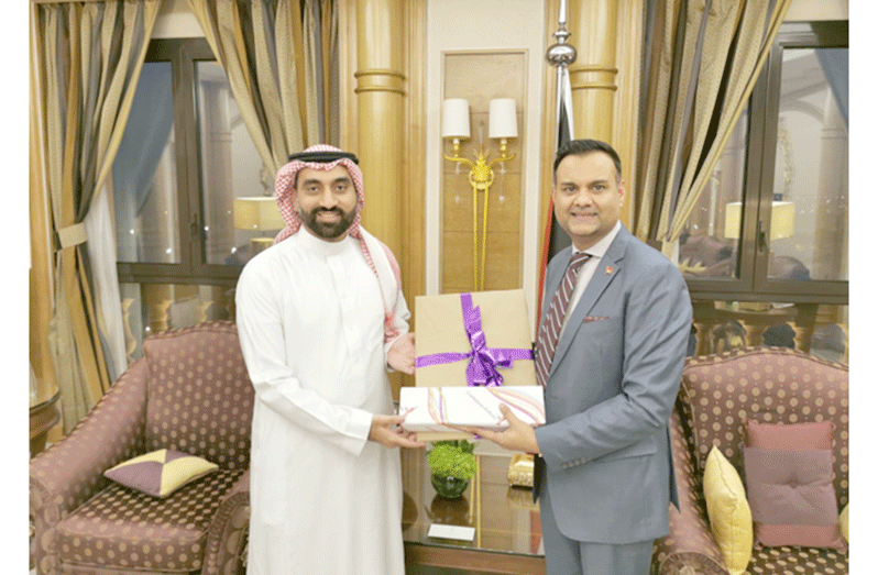 Caribbean Airlines’ Chairman, Ronnie Mohammed (right), presents Rashed Alshammair, Vice President of Commercial from Saudi Arabia's Air Connectivity Program (ACP), with a gift after their strategic meeting