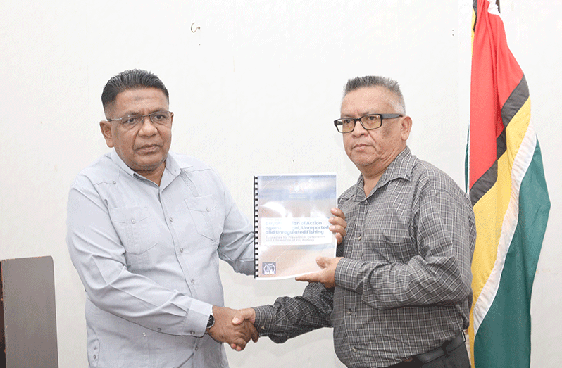 Agriculture Minister Zulfikar Mustapha while handing over the document to the Ministry's CFO, Denzil Roberts