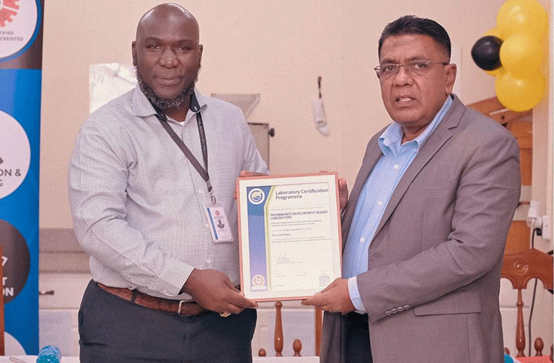 The Minister of Agriculture, Zulfikar Mustapha (right), receives a certificate and a plaque from GNBS Executive Director (ag) at the event on Thursday