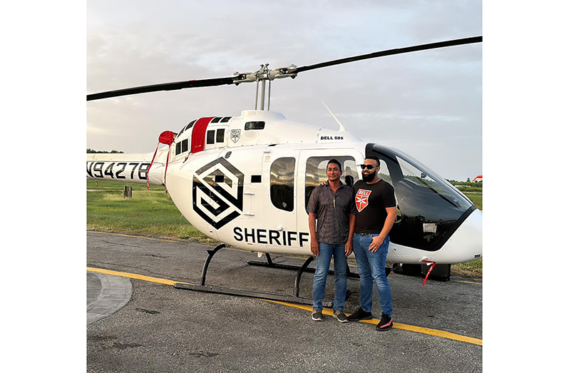 The Managing Director of the Sheriff Group of Companies, Ameir Ahmad (right), and dad, Shareef Ahmad, with their recent Bell 505