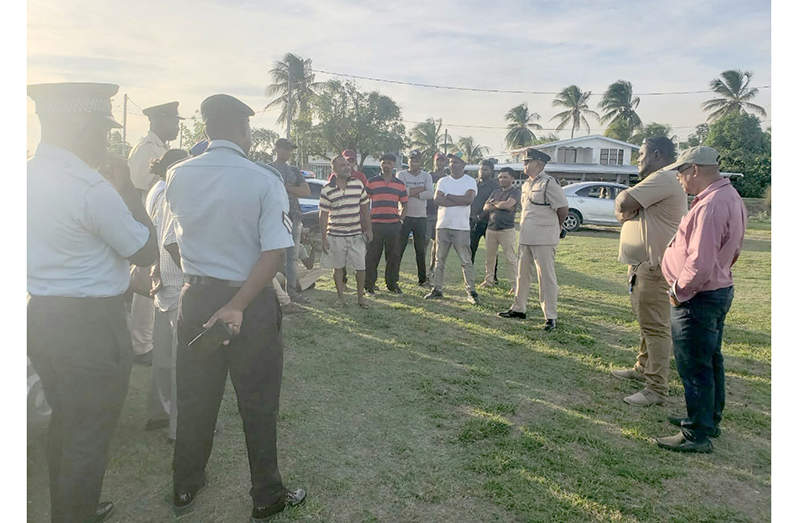 Assistant Commissioner Khali Pareshram (third from right) speaking with Cane Grove residents about issues affecting the community