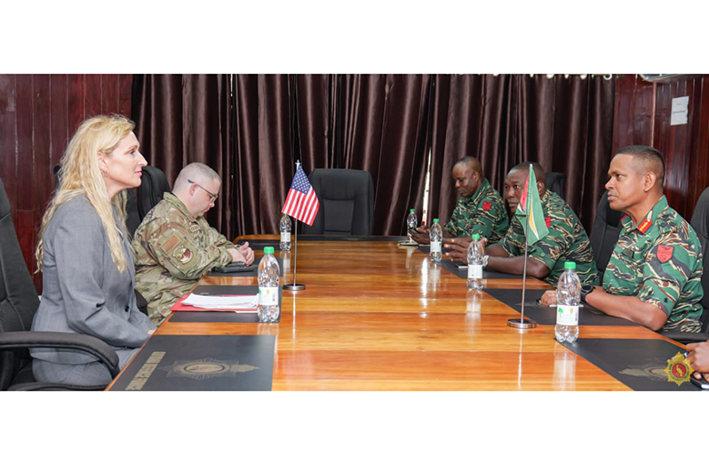 US Ambassador to Guyana, Nicole Theriot and Chief-of-Staff Brigadier Omar Khan flanked by other military officials during their discussions