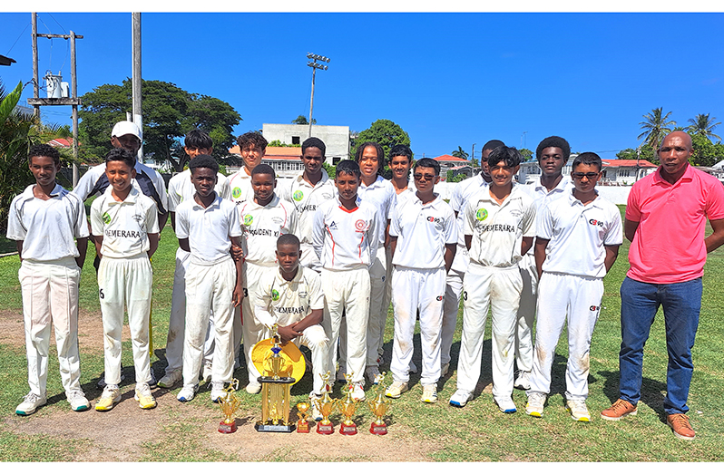 GT’s Skipper Emmanuel Lewis (stooping) with his team which won the DCB Inter-Association 50-over U-15 tournament yesterday (Sean Devers photos)