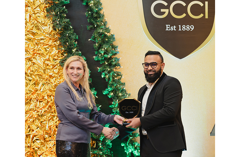 Ameir Ahmad receives his award from US Ambassador to Guyana, Nicole Theriot (Sheriff Group photo)